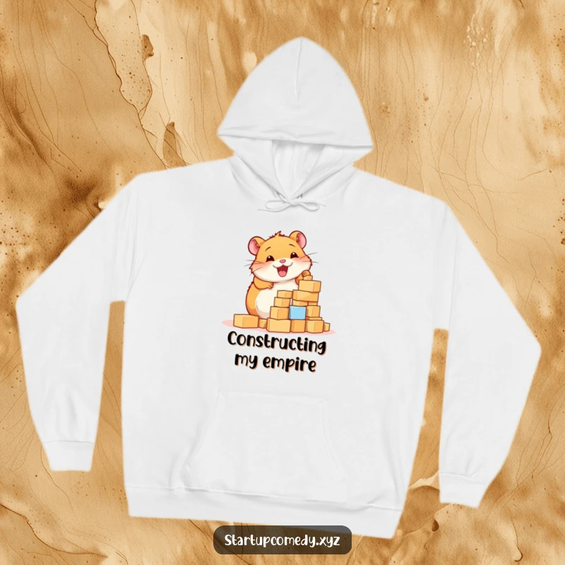 Funny Hamster Hoodie, a cheerful hamster enthusiastically building a tower of tiny blocks, exuding warmth and industriousness.