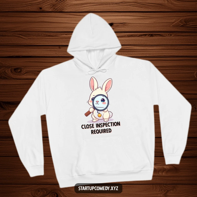 Funny bunny hoodie, brave rabbit examining tiny detail with magnifying glass, cozy apparel, investigative spirit gift.